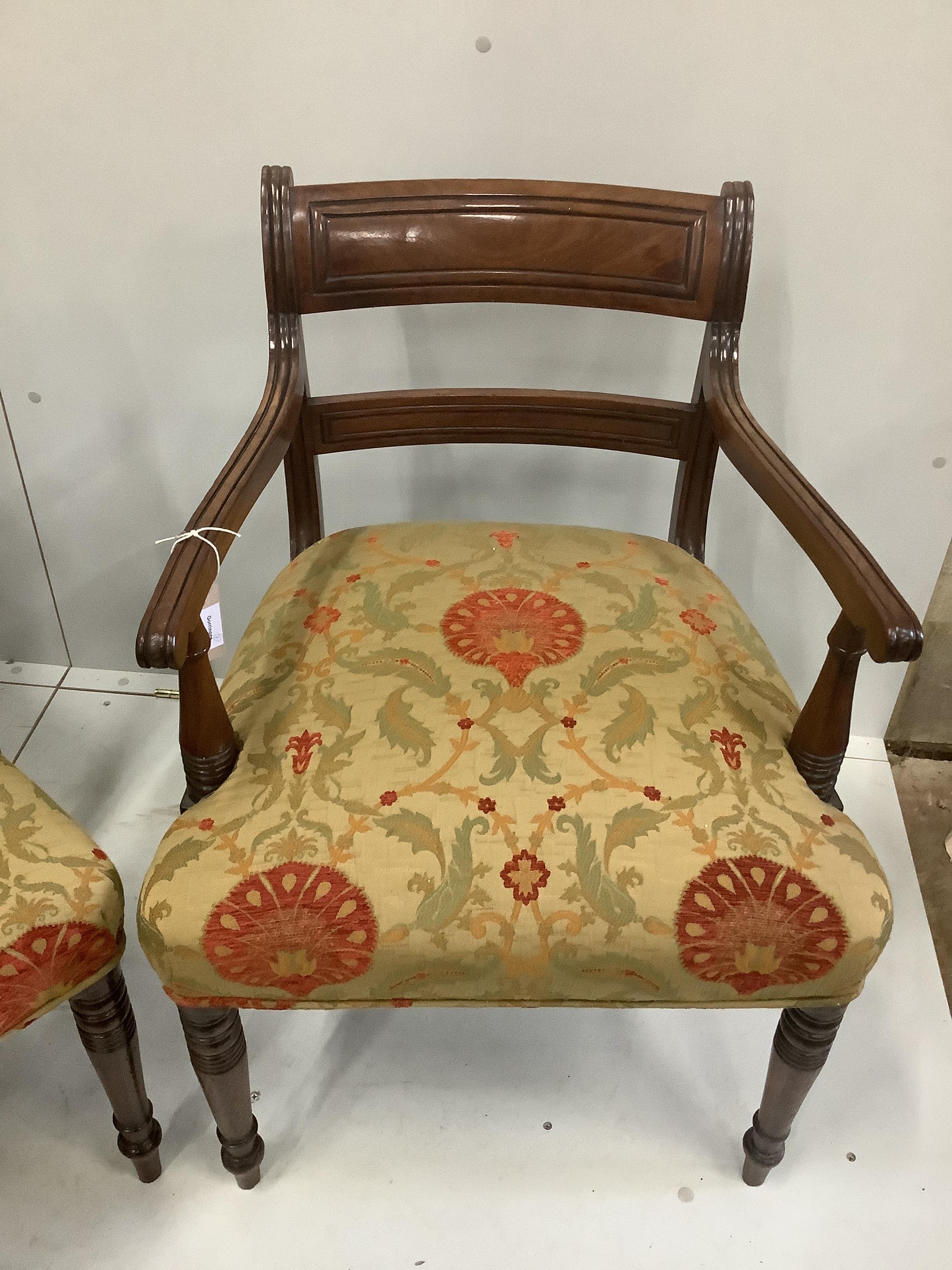 A set of seven Regency mahogany dining chairs with tablet cresting rails, upholstered seats on turned legs, including one carver